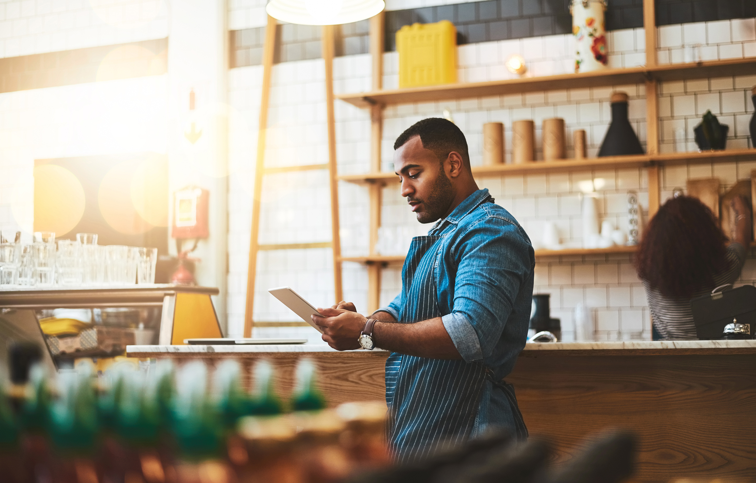 BB_Man shop owner looking at tablet.jpg